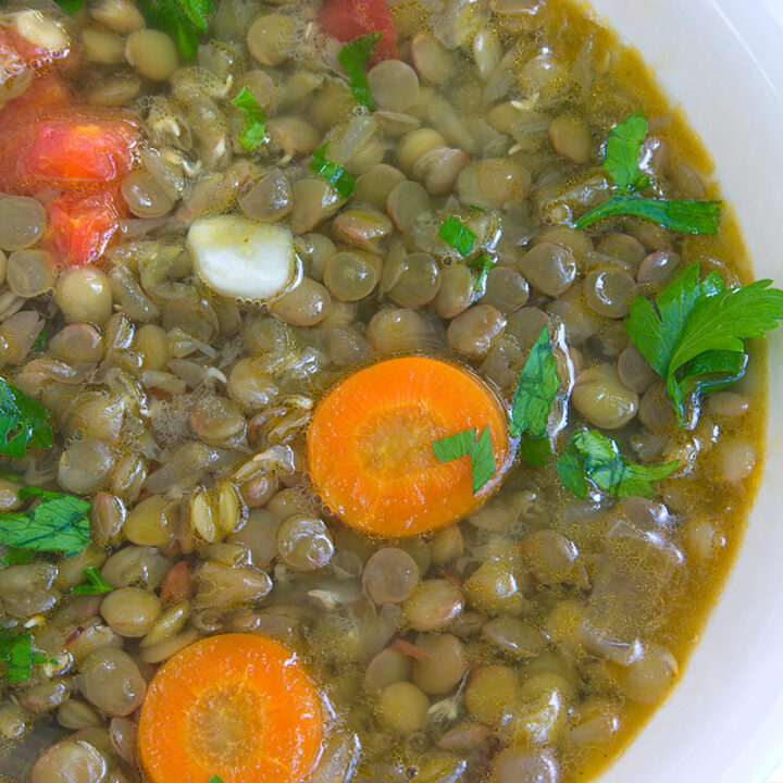 closeup of soup with lentil ,carrot,tomato,garlic and parsley